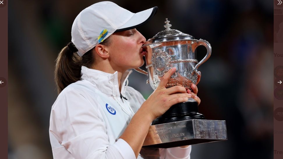 Iga Swiatek mencium trofi Coupe Suzanne Lenglen usai memenangi laga final tunggal putri French Open 2022 yang digelar pada Sabtu (4/6/2022).