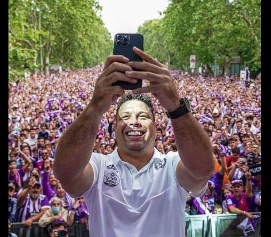Ronaldo Nazario mengambil foto selfie dengan layar belakang penggemar Real Valladolid saat perayaan mereka promosi ke LaLIga.